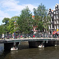 A green bridge with many bicycles, over the Herengracht canal - Amsterdam, Nederland